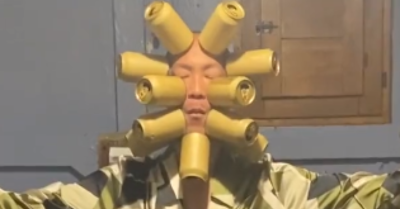 Japanese Man Sticks 11 Cans To His Head Using Air Suction, Creates New World Record