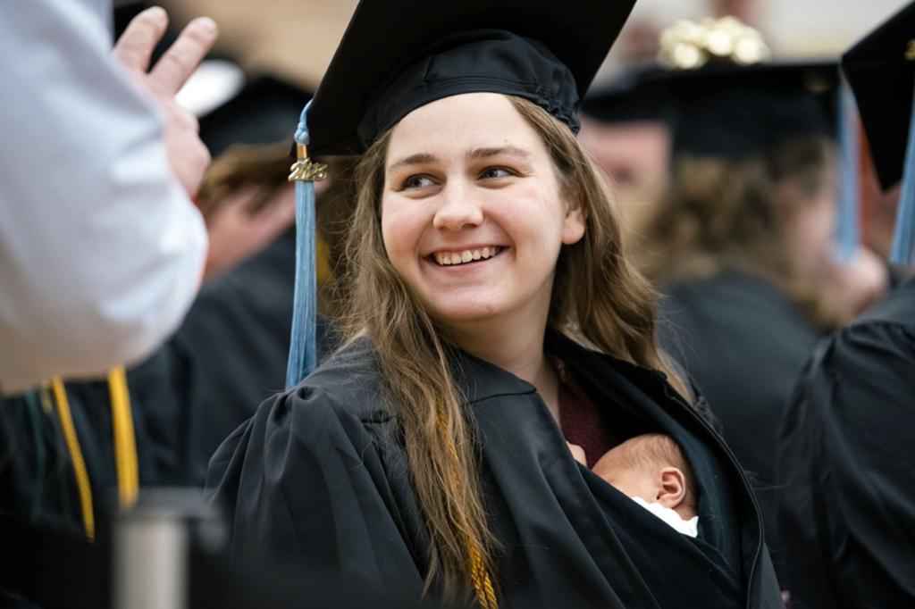 Michigan woman walks across stage at college graduation with her 10-day-old daughter in a gown
